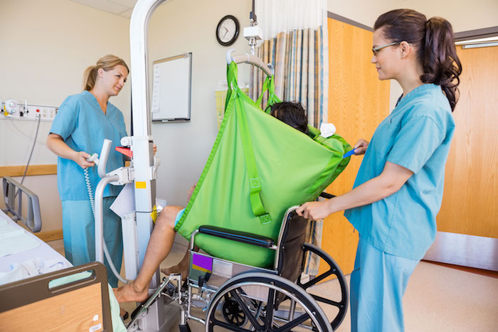 Nurses lifting a patient